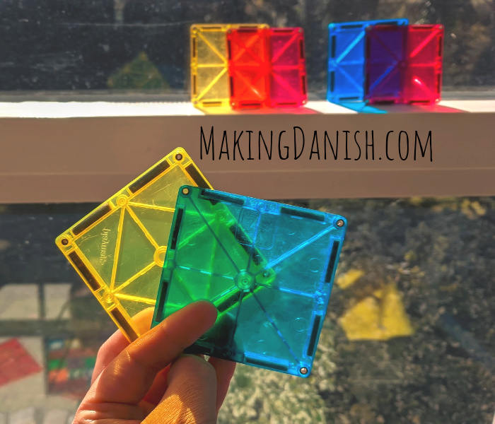 Two differently colored translucent magnetic tiles forming a new color - small activity for younger kids.