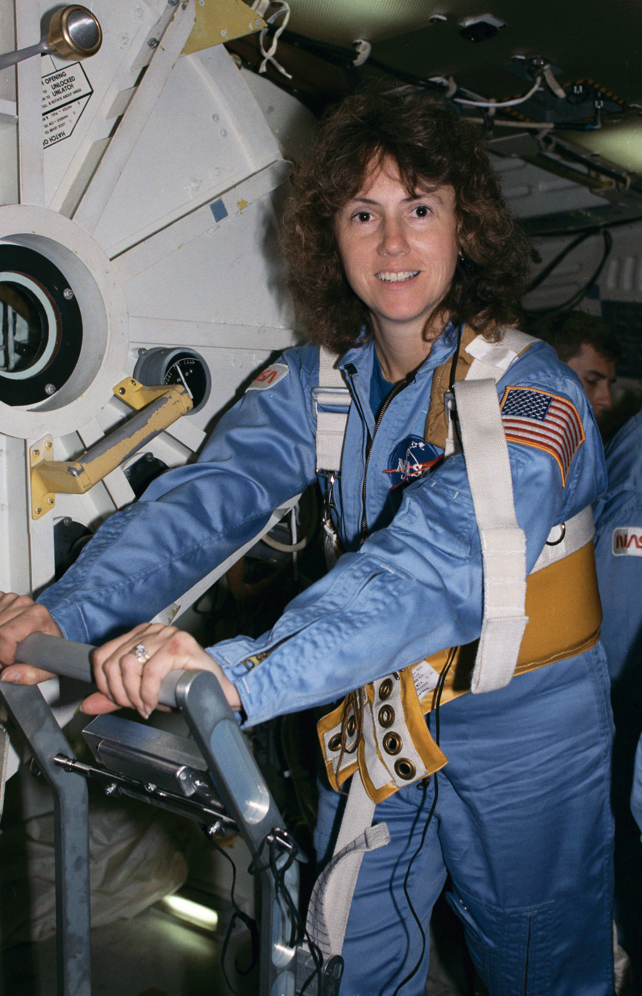 Christa McAuliffe, astronaut on the Challenger space shuttle training on treadmill for the mission.