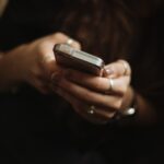 A person holding cell phone in hands.