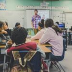 Classroom, teacher teaching to the students.