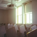 Empty chairs in a classroom.