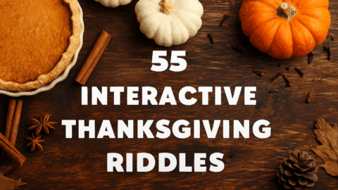Top-down photo of a wooden table decorated for Thanksgiving with a pumpkin pie, cinnamon sticks, pinecones, orange and white pumpkins, and autumn leaves. The bold white text in the center reads “55 Interactive Thanksgiving Riddles.”